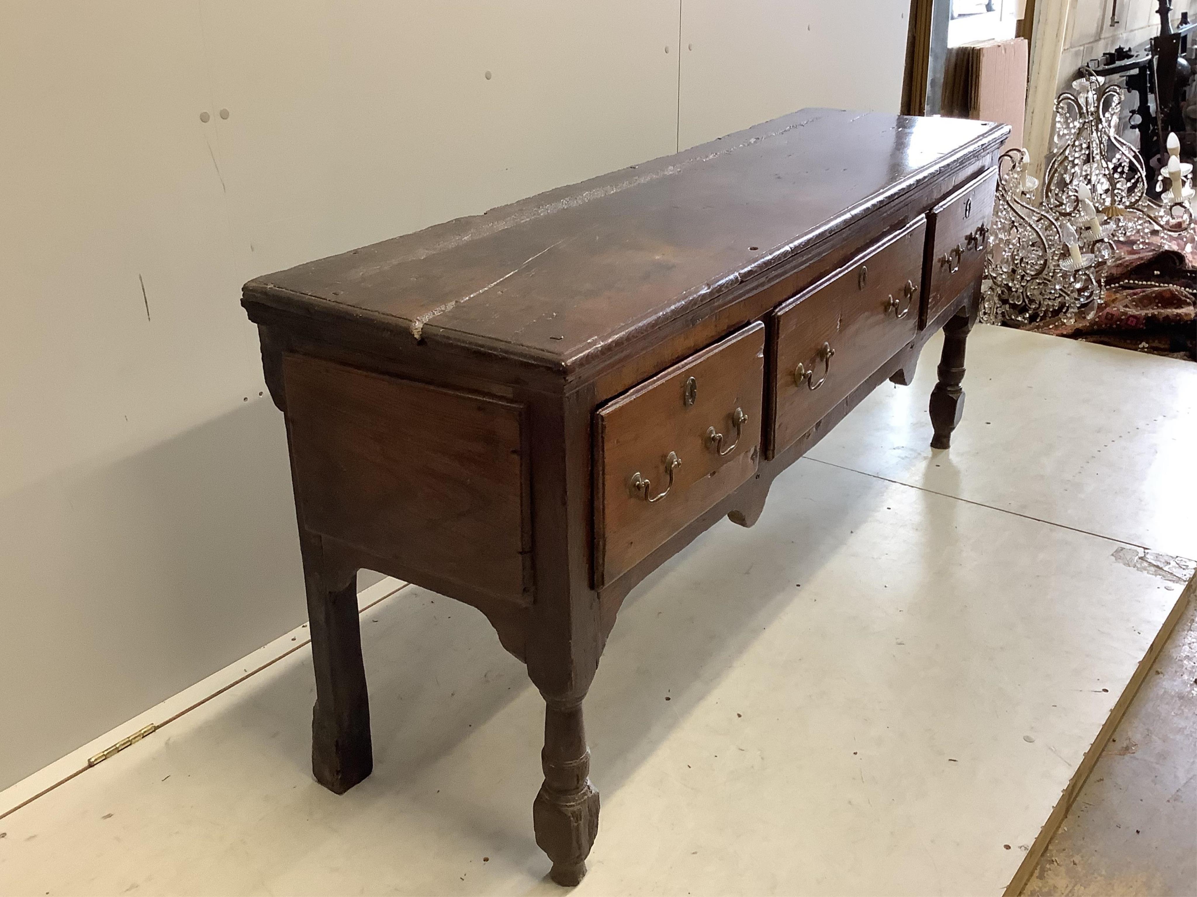 An 18th century oak low dresser, width 172cm, depth 46cm, height 74cm. Condition - poor to fair